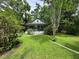A single-story bungalow-style house with a quaint front porch, surrounded by a lush lawn and greenery at 1640 Dogwood Rd, Charleston, SC 29414