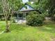 Bungalow-style house with a front porch, a yard, and abundant surrounding greenery at 1640 Dogwood Rd, Charleston, SC 29414