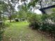 Lawn in the front yard has bushes around the front porch; home has a dark roof at 1640 Dogwood Rd, Charleston, SC 29414