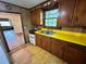 Spacious kitchen with wooden cabinetry, bright yellow countertops, and window with natural light at 1640 Dogwood Rd, Charleston, SC 29414