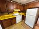 Kitchen with white appliances, wooden cabinets, and yellow counter tops showing its full potential at 1640 Dogwood Rd, Charleston, SC 29414