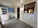 Bright room with white walls and tile flooring offers a view of the kitchen through a window at 1640 Dogwood Rd, Charleston, SC 29414