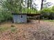 Exterior shed on a wooded lot offers storage space or could be converted at 1640 Dogwood Rd, Charleston, SC 29414