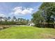 Expansive backyard with lush green lawn, mature trees, play set, and a charming shed; ideal for outdoor activities at 1866 Capri Dr, Charleston, SC 29407