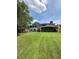 Lush backyard with sprawling lawn, mature trees, patio, and swing set offers plenty of space to play at 1866 Capri Dr, Charleston, SC 29407