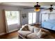 Bedroom featuring neutral tones, a large window, a ceiling fan, and access to the outdoors at 1866 Capri Dr, Charleston, SC 29407