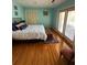 Bedroom features hardwood floors, a bed with blue accents, and doors to the outside at 1866 Capri Dr, Charleston, SC 29407