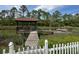 Private dock with a gazebo overlooking the serene water views, surrounded by natural marsh grasses at 1866 Capri Dr, Charleston, SC 29407