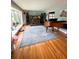 Spacious living room with hardwood floors, a large window, vintage organ and a beautiful area rug at 1866 Capri Dr, Charleston, SC 29407