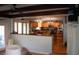 Bright, open-concept living room with wooden beams and bar-style seating overlooking the kitchen at 1866 Capri Dr, Charleston, SC 29407