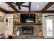 Cozy living room showcasing a brick fireplace, exposed wood beams, and neutral wall color at 1866 Capri Dr, Charleston, SC 29407