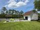 Backyard featuring a barn, a basketball hoop, a fire pit, seating, and lovely trees at 1866 Capri Dr, Charleston, SC 29407