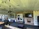 Relaxing covered patio with brick fireplace, outdoor furniture, and string lights, perfect for entertaining guests at 1866 Capri Dr, Charleston, SC 29407