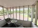 Enclosed porch with outdoor view; chairs, table, and trees visible outside the structure at 1866 Capri Dr, Charleston, SC 29407