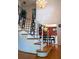 Staircase with wood treads, white risers, wrought iron railing, and chandelier, leading to the second floor at 1866 Capri Dr, Charleston, SC 29407