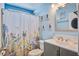 Charming bathroom featuring a floral shower curtain and a gray vanity with a white countertop sink at 2017 Asher Loop, Summerville, SC 29485