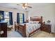 Comfortable bedroom with wood furniture, neutral walls, and ample natural light from the double windows at 2017 Asher Loop, Summerville, SC 29485