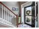 Inviting home foyer with staircase, decorative table, and a view of the front door at 2017 Asher Loop, Summerville, SC 29485