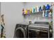 Well-organized laundry room with modern washer and dryer units, shelving, and ample storage space at 2017 Asher Loop, Summerville, SC 29485