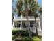 Charming two-story home with double porches framed by majestic palm trees at 205 Delahow St, Daniel Island, SC 29492