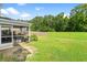 Expansive backyard with well-maintained lawn, wooden fence, and screened-in porch at 251 Coosawatchie St, Summerville, SC 29485