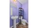Charming powder room featuring a pedestal sink, toilet, and modern shelving at 251 Coosawatchie St, Summerville, SC 29485