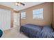 Comfortable bedroom with carpet flooring, closet space, and natural light from two windows at 251 Coosawatchie St, Summerville, SC 29485