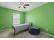 Bright bedroom featuring green walls, carpet floors, a ceiling fan, and large window for ample natural light at 251 Coosawatchie St, Summerville, SC 29485