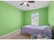 Bright bedroom with green walls, ceiling fan, and natural light from a window at 251 Coosawatchie St, Summerville, SC 29485