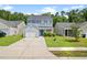 Charming two-story home with blue accents, a one-car garage, and a well-manicured front lawn at 251 Coosawatchie St, Summerville, SC 29485