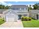 Inviting two-story home with blue siding, a one-car garage, and a landscaped front yard at 251 Coosawatchie St, Summerville, SC 29485