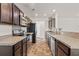 Functional kitchen with dark wood cabinets, stainless steel appliances, and stone-style countertops at 251 Coosawatchie St, Summerville, SC 29485