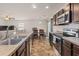 Spacious kitchen featuring a double sink, stainless steel appliances, and views into the adjacent dining area at 251 Coosawatchie St, Summerville, SC 29485