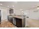 Open kitchen featuring dark cabinets, a stainless steel dishwasher, and seamless connection to the living area at 251 Coosawatchie St, Summerville, SC 29485