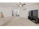 Spacious carpeted living room with stairs and television at 251 Coosawatchie St, Summerville, SC 29485