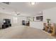 Open concept living room features neutral carpet, plenty of natural light, and an attached dining area at 251 Coosawatchie St, Summerville, SC 29485