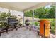 Covered patio featuring cooking grills, plants, and a view of the wooded backyard at 251 Coosawatchie St, Summerville, SC 29485