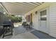 Relaxing covered back porch with seating area, a grill and access to the backyard at 2605 Mona Ave, Charleston, SC 29414