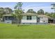 Expansive backyard featuring lush green lawn, mature trees, and a cozy outdoor deck at 2605 Mona Ave, Charleston, SC 29414