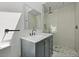 Modern bathroom featuring a blue vanity, marble countertop, and a tiled glass enclosed shower at 2605 Mona Ave, Charleston, SC 29414