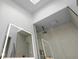Contemporary bathroom with a glass shower, a ceiling skylight and sleek LED illuminated mirror at 2605 Mona Ave, Charleston, SC 29414