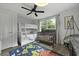 Bright bedroom showcasing a bunk bed, crib, ceiling fan and world map rug at 2605 Mona Ave, Charleston, SC 29414