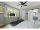 Relaxing bedroom featuring a gray dresser, ceiling fan and ensuite bathroom access at 2605 Mona Ave, Charleston, SC 29414