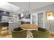 Charming dining area connects to the updated kitchen, featuring a wooden table and comfortable green chairs at 2605 Mona Ave, Charleston, SC 29414