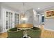 Elegant dining area features a round table with green chairs and a unique antler chandelier at 2605 Mona Ave, Charleston, SC 29414
