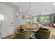 Bright dining area with a wood table, green chairs, and stylish antler chandelier at 2605 Mona Ave, Charleston, SC 29414