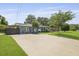 Charming blue home boasts a well-manicured lawn and a large concrete driveway and inviting curb appeal at 2605 Mona Ave, Charleston, SC 29414