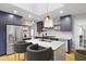 Modern kitchen with stainless steel appliances, navy cabinets, and a white marble island with seating at 2605 Mona Ave, Charleston, SC 29414