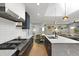 Modern open-concept kitchen with stainless steel appliances, blue cabinets, and a dining area in view at 2605 Mona Ave, Charleston, SC 29414