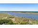 Stunning aerial view showcasing the waterway and waterfront property with multiple piers at 2649 Starfish Dr, Johns Island, SC 29455